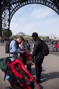 Buying some souvenirs under the Eiffel Tower